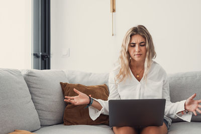 Young woman using laptop at home