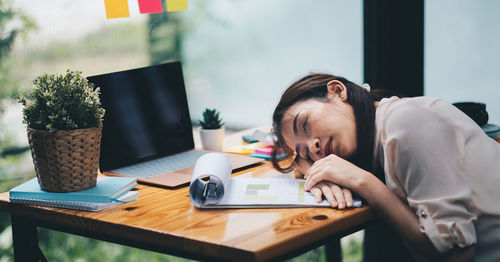 Woman sleeping at office desk
