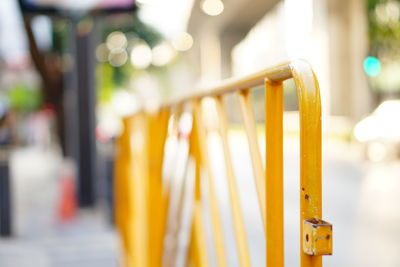 Close-up of yellow bell hanging on street