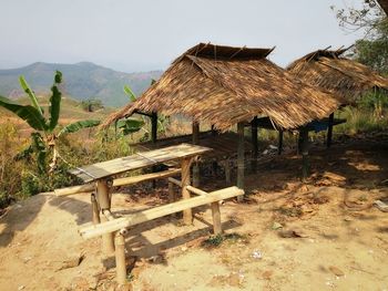 Hut on mountain against sky