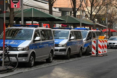 Cars on road against sky in city