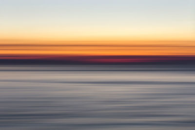 Scenic view of sea against sky at sunset