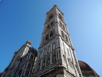 Low angle view of historic building against clear blue sky