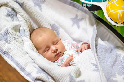 High angle view of cute baby boy sleeping on bed