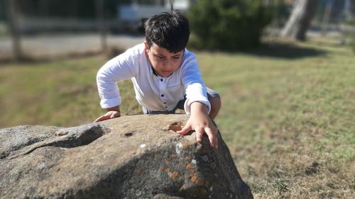 Full length of young man on rock