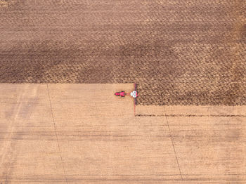 Aerial view of combine harvester harvesting at farm