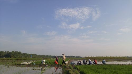 People on field against sky