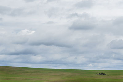 Scenic view of landscape against cloudy sky