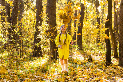 Full length of woman standing in forest