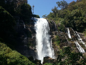 Low angle view of waterfall against sky