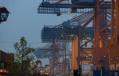 Low angle view of illuminated pier against sky in city