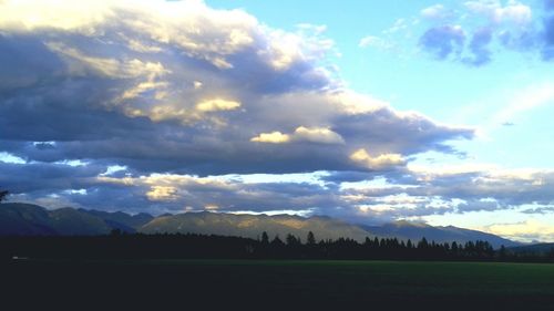 Scenic view of mountains against cloudy sky