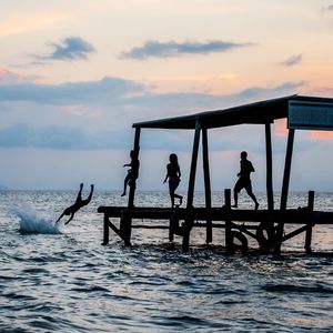 People on beach at sunset