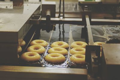 Close-up of doughnuts cooking in a deep fryer 