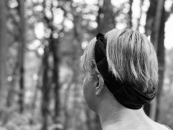 Rear view of woman walking in woodlands