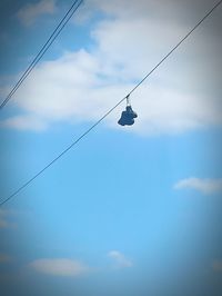 Low angle view of overhead cable against sky