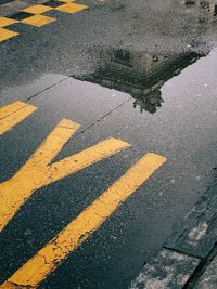 Building reflection on a wet taxi sign