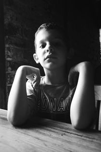 Portrait of boy sitting on table