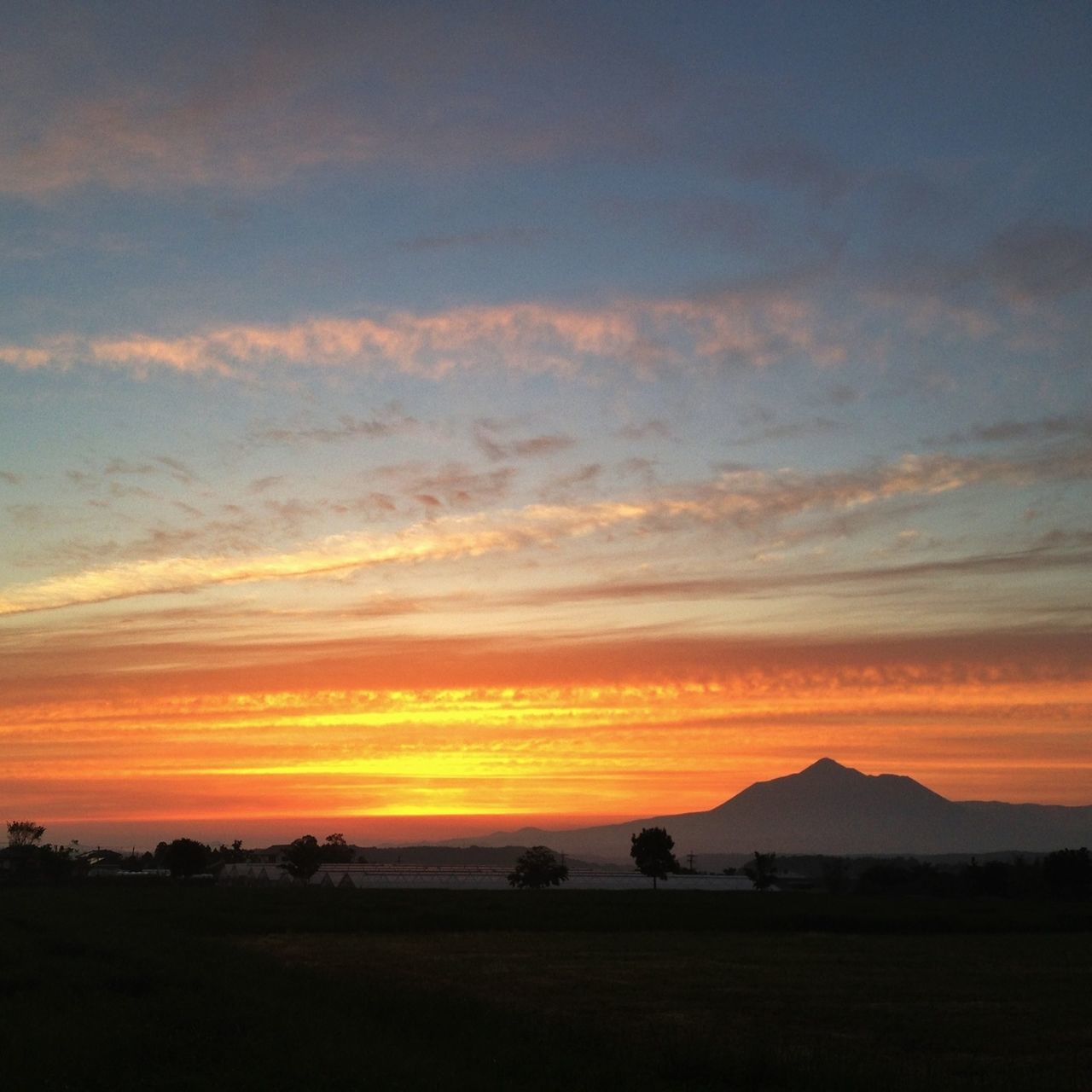 sunset, scenics, orange color, sky, tranquil scene, silhouette, tranquility, beauty in nature, landscape, cloud - sky, idyllic, nature, dramatic sky, mountain, cloud, non-urban scene, outdoors, majestic, moody sky, dusk