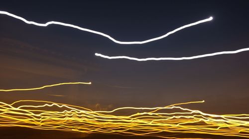 Light trails against sky at night