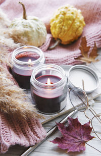 Autumn still life with pumpkins and burning candles. cozy fall composition