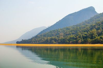 Scenic view of lake and mountains against sky