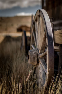 Close-up of rusty wheel on field