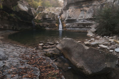 View of stream flowing through rocks