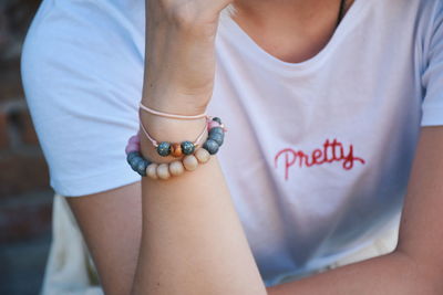 Midsection of woman wearing bracelet