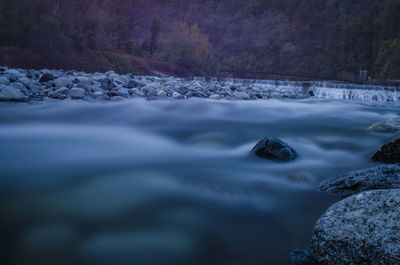 Surface level of snow covered landscape against the sky