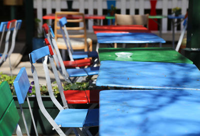 Chairs arranged by table at sidewalk cafe