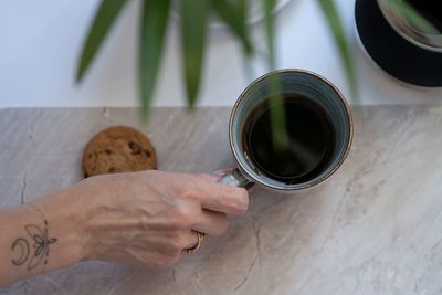 High angle view of woman hand holding drink