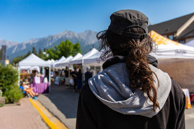 Rear view of woman looking at market stall