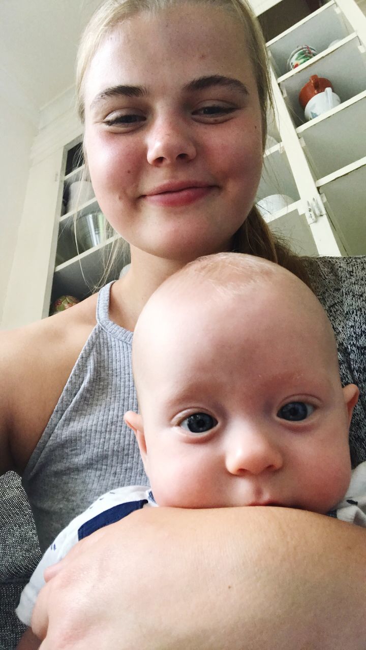 real people, baby, looking at camera, childhood, innocence, togetherness, two people, portrait, babyhood, cute, indoors, bonding, love, family, leisure activity, headshot, lifestyles, close-up, day, smiling