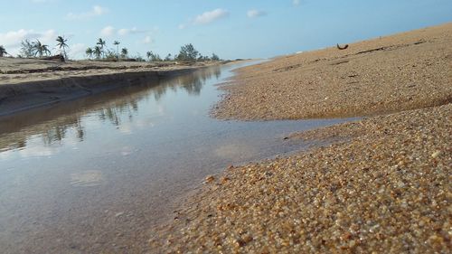 Surface level of beach against sky