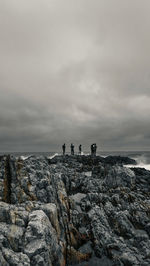 Lighthouse by sea against sky