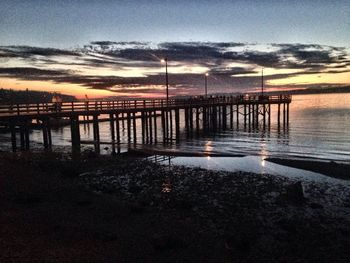 Pier on sea at sunset