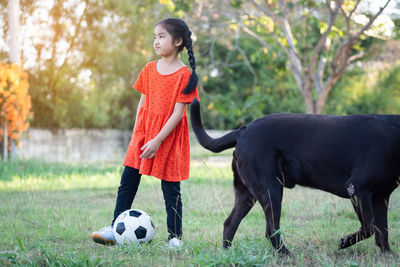 Full length of woman standing on soccer field