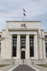 Flag on built structure against sky