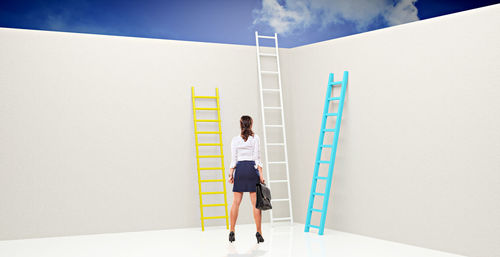 Woman standing on wall of building