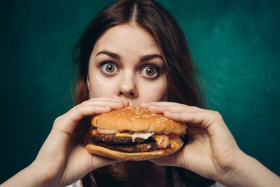 Portrait of woman holding burger
