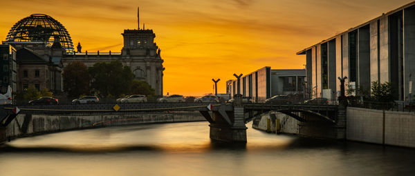 Bridge over river during sunset