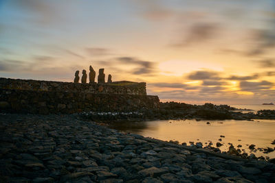 Scenic view of beach against sky during sunset on easter island