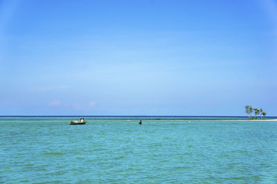 Scenic view of sea against blue sky