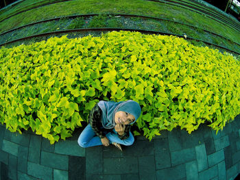 Portrait of woman with green leaves