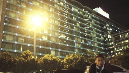 Low angle view of illuminated buildings in city at night