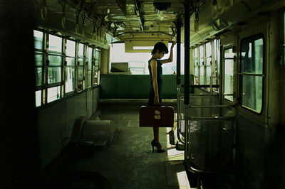 Woman standing in abandoned bus