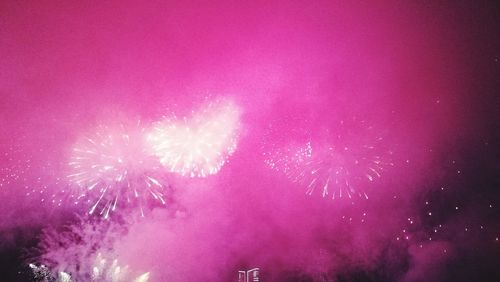 Low angle view of firework display at night