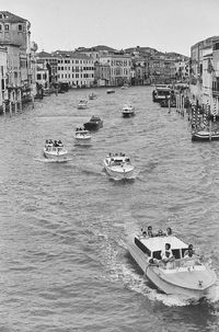 Boats in river with buildings in background