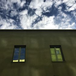 Low angle view of building against cloudy sky